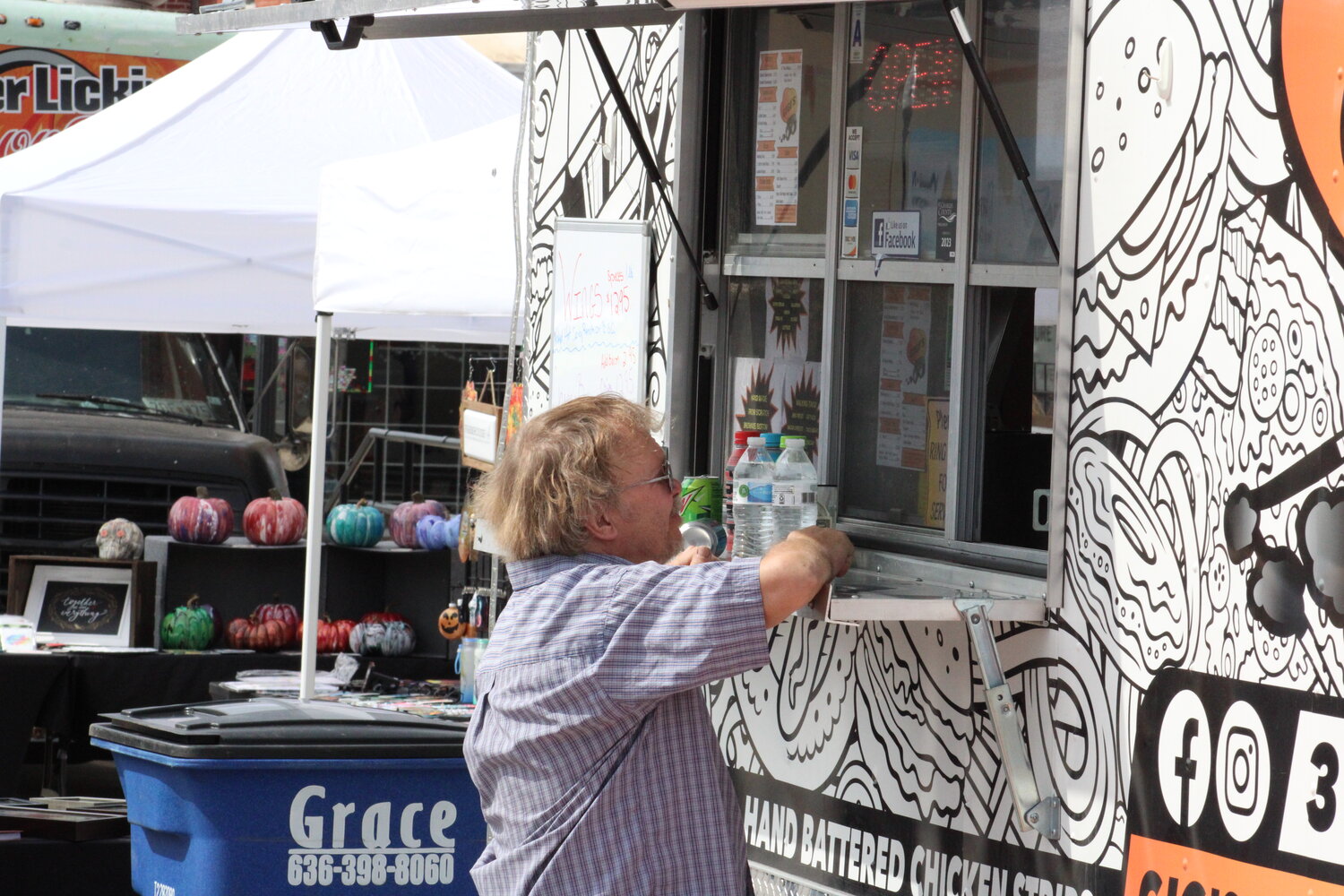 A man orders at one of the food trucks at the Fall Festival.