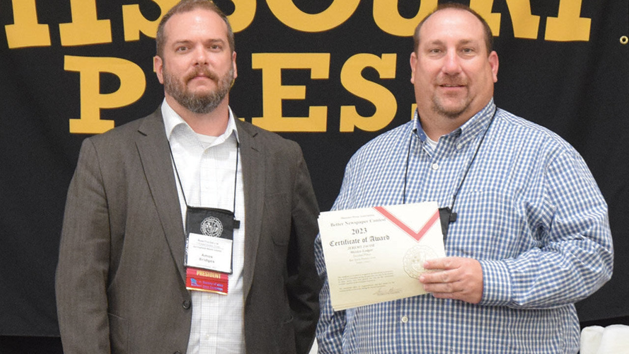 Warren County Record Publisher Tim Schmidt, right, accepts an award for Best Front Page presented to the newspaper for their work in 2022. Also pictured is Amos Bridges, editor-in-chief of the Springfield News-Leader and Missouri Press Association acting president.