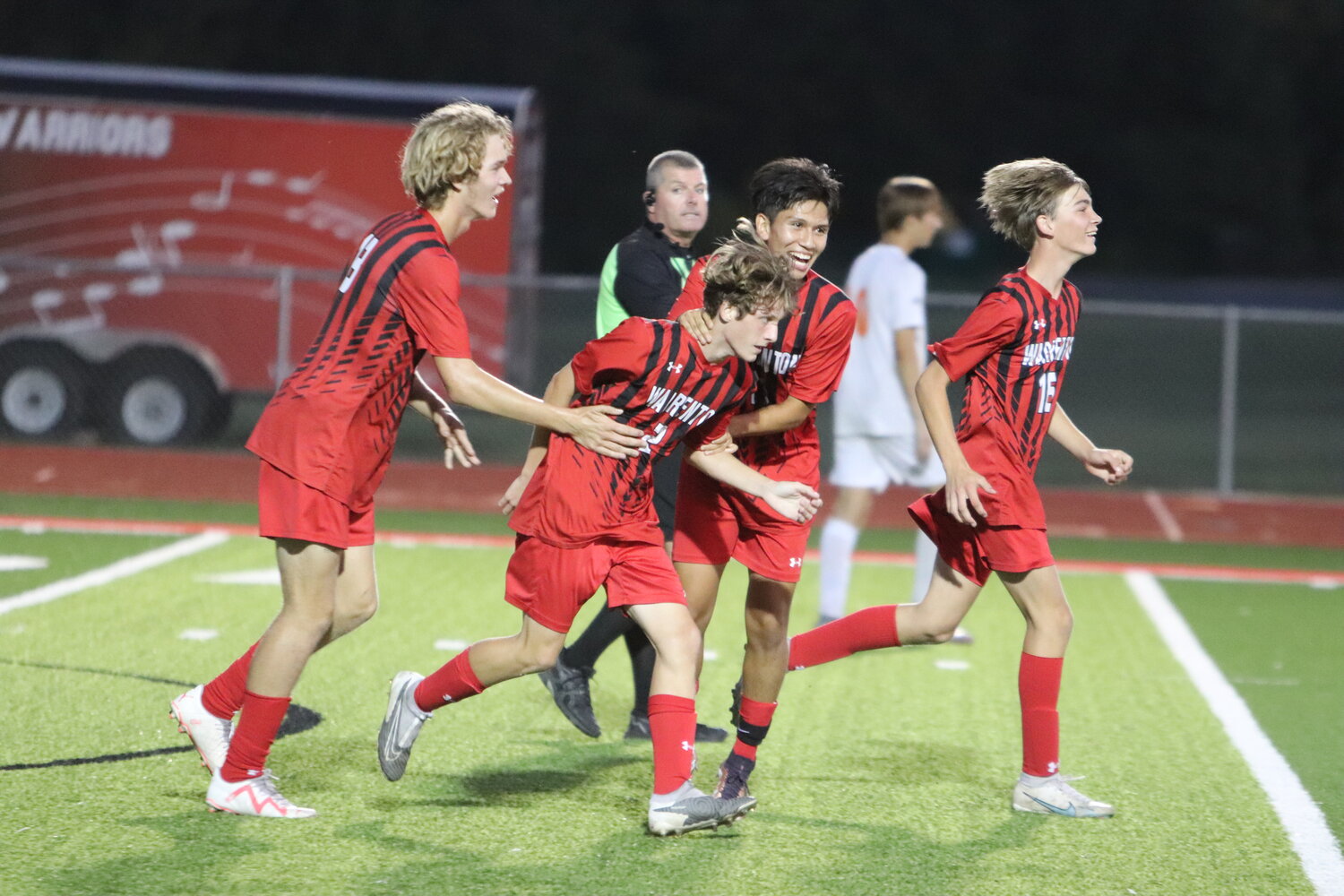 Warrenton’s Nolan Donovan (second from left) and Bryan Guerrero (right) celebrate after Donovan scored a goal in the second half of Warrenton’s 3-2 home loss to North Point last week.