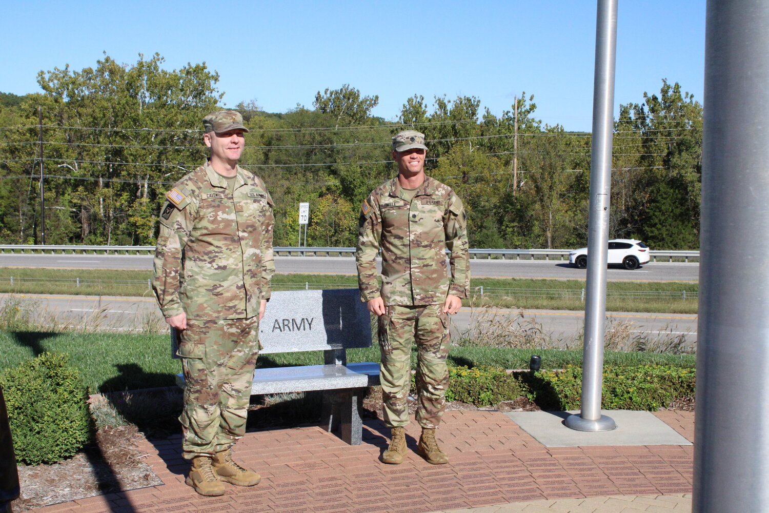 Lt. Col. Joseph Caldwell and Lt. Col. Tyson Mele stand in front of the U.S. Army bench at the Tribute to Veterans Memorial in Warrenton on Oct. 7.