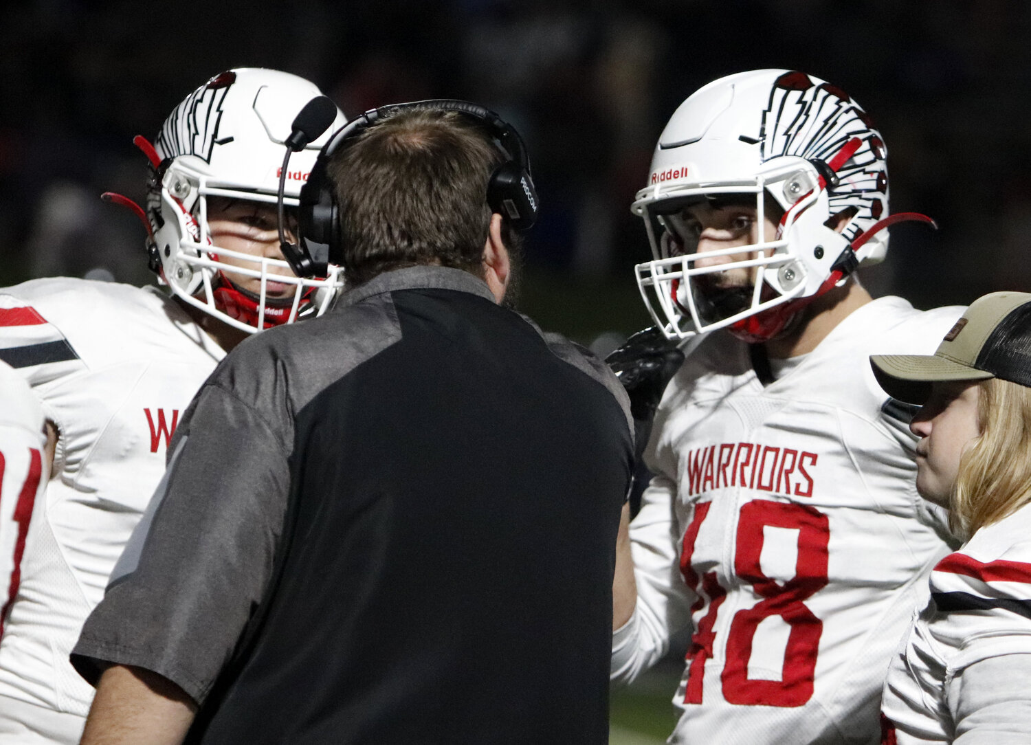 Warrenton seniors Aidan Bond and Jacob Ruff listen to Warrenton defensive coordinator John Jeskey during a timeout in the first half of Warrenton’s overtime win over Parkway North. Ruff registered one of two overtime sacks in the win.