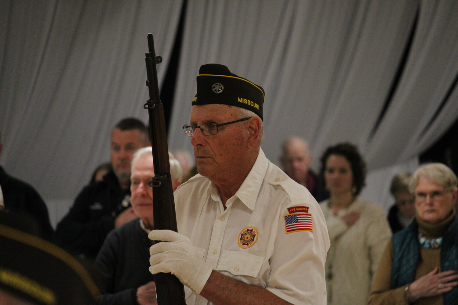 A member of the color guard stands at attention.