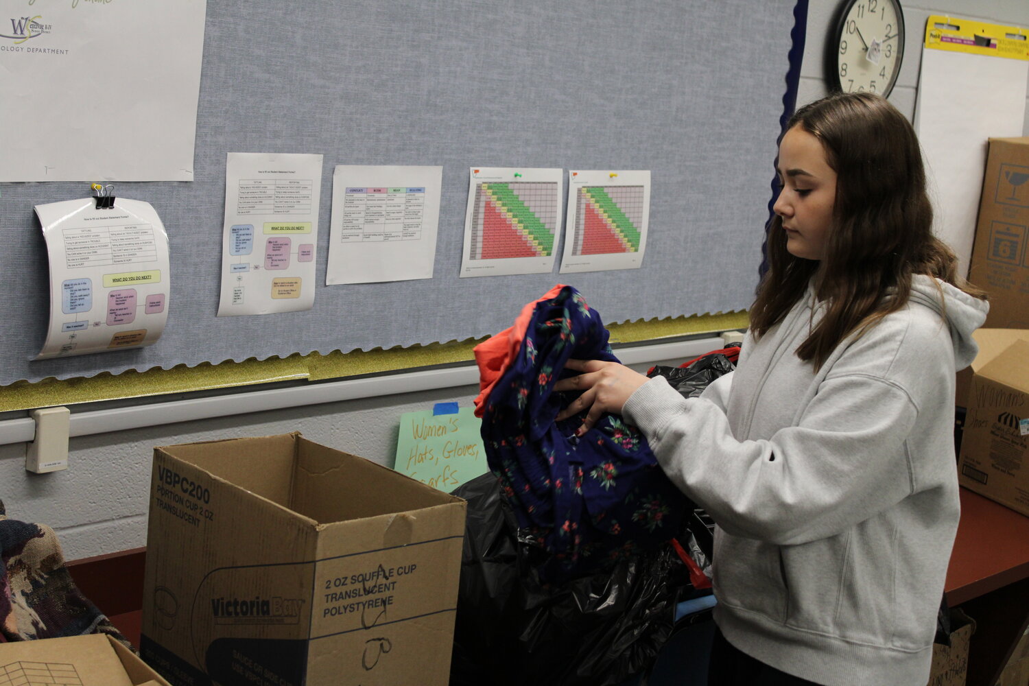 McKenzie Fry works to organize items donated to homeless veterans.