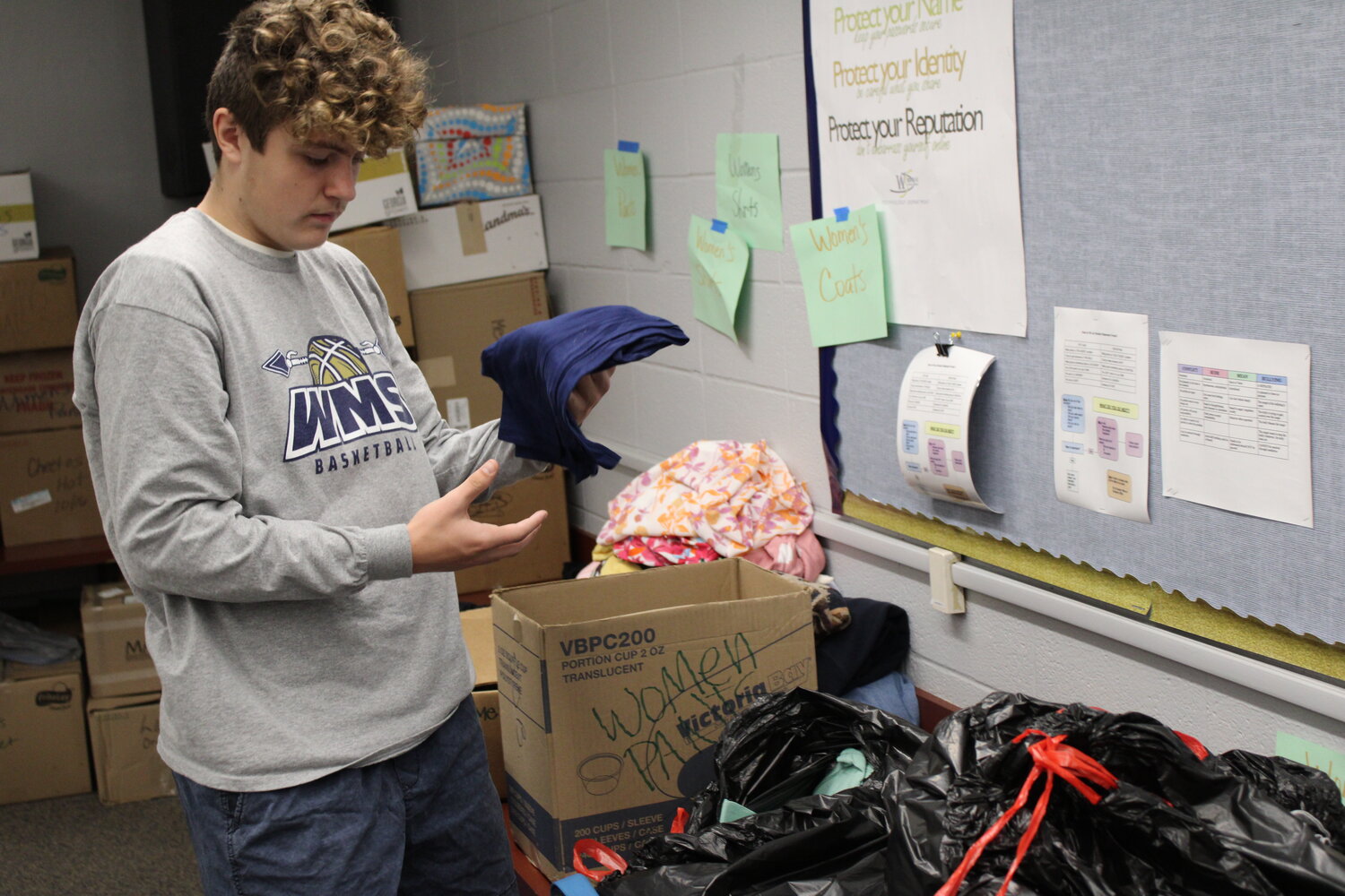 Logan Van Scoy inspects some of the donated items.