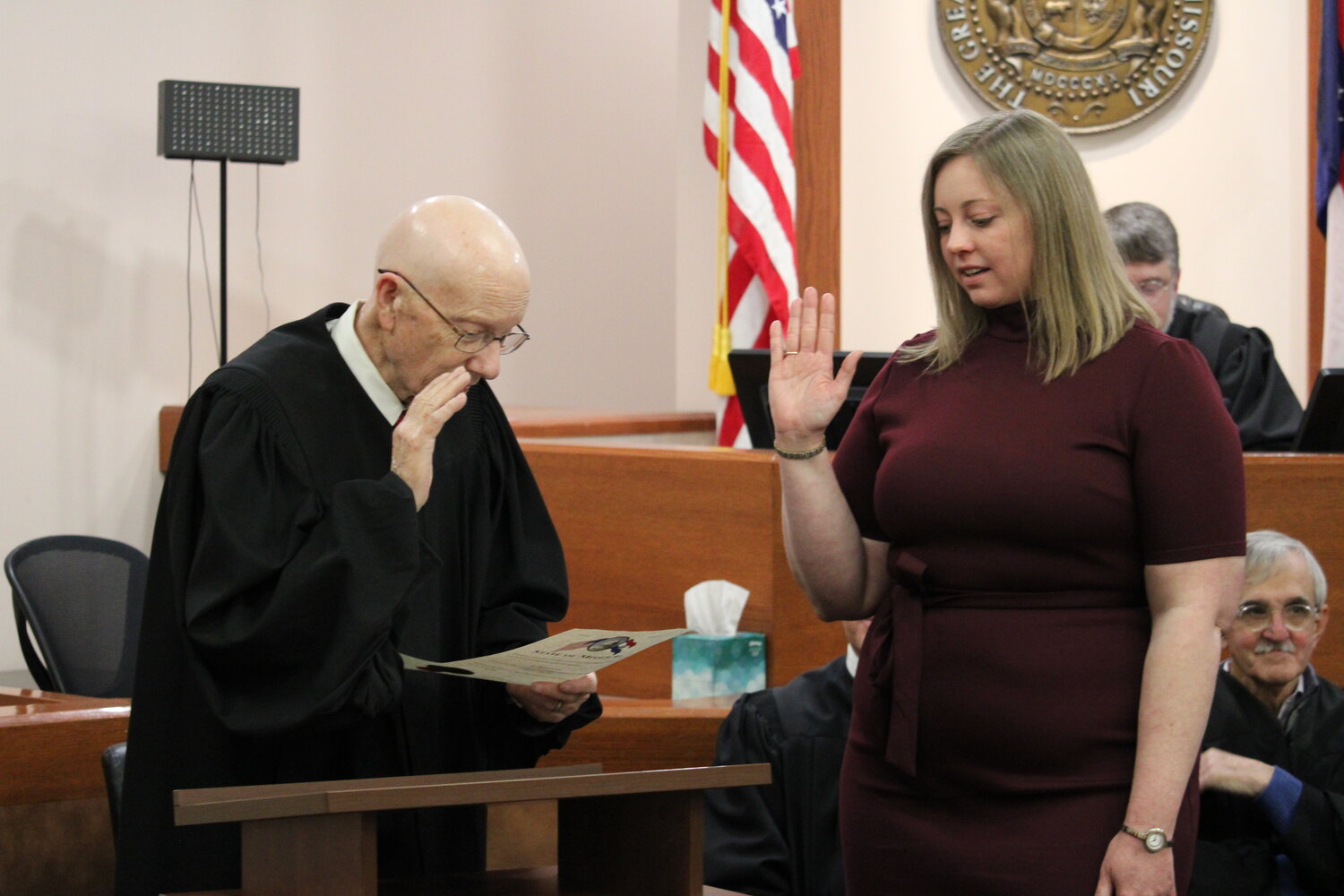 Katie Joyce, right, takes her oath of office as she is installed as a judge by senior Judge Keith Sutherland during a ceremony Dec. 4 at the Warren County Courthouse.
