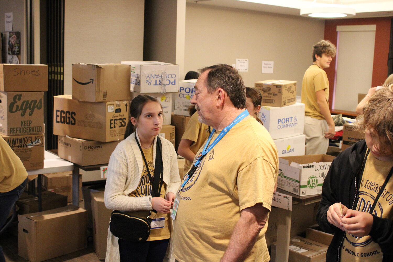 Truesdale Mayor Jerry Cannon, who is also a teacher and student council sponsor at Wentzville Middle School, talks to Cecilia White as students unload the donations.