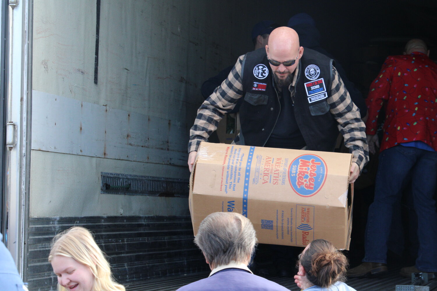 Volunteers unload the wreaths at the Holy Rosary Parish Center on Dec. 9.