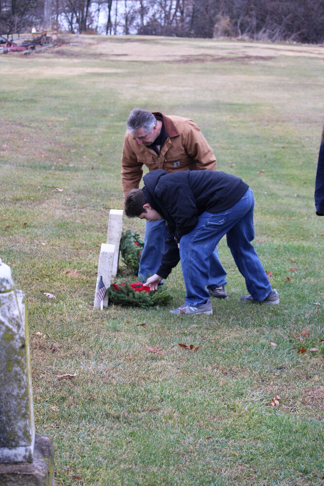 Volunteers lay wreaths to honor veterans during the Wreaths Across America ceremony on Dec. 16.