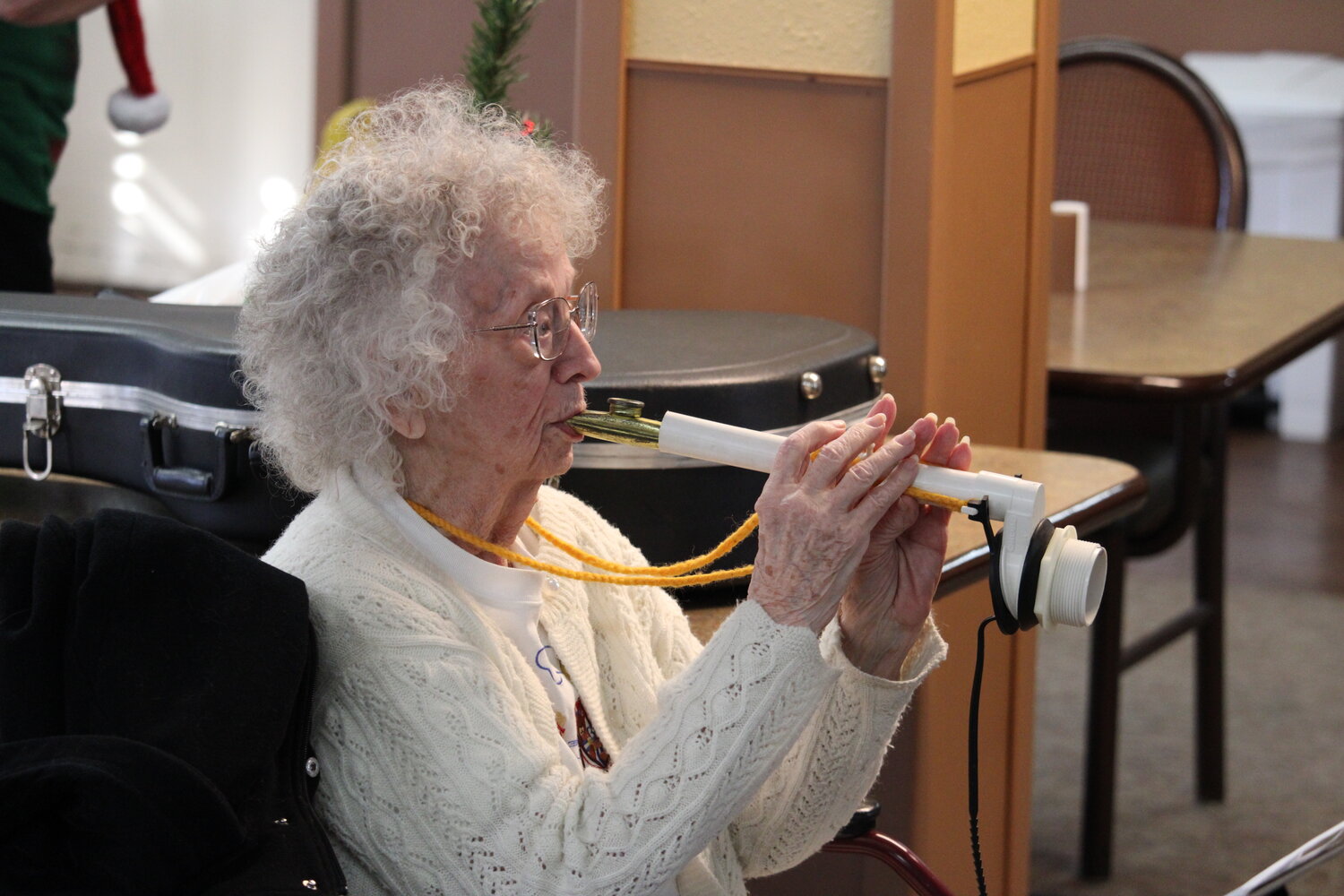 Glorida Bell, of Wright City, plays her kitchen instrument as she leads residents of Warrenton Manor in “Jingle Bells” on Dec. 18.