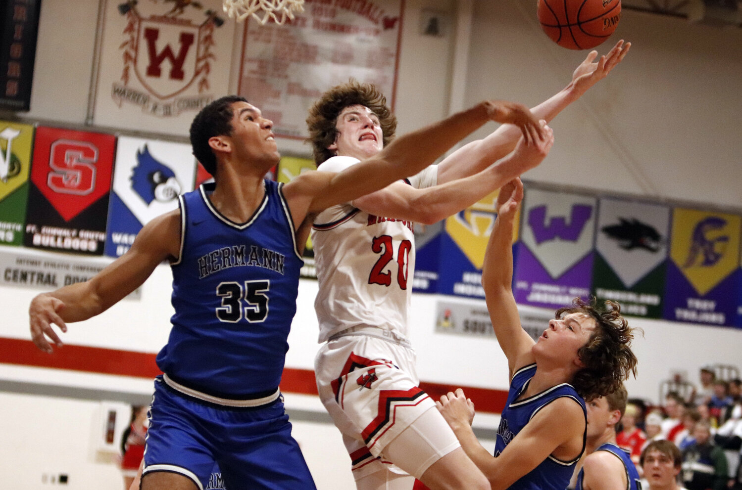 Troy Anderson attempts a layup over Hermann center Daeden Hopkins during the first half of Warrenton’s win over Hermann on Friday night.