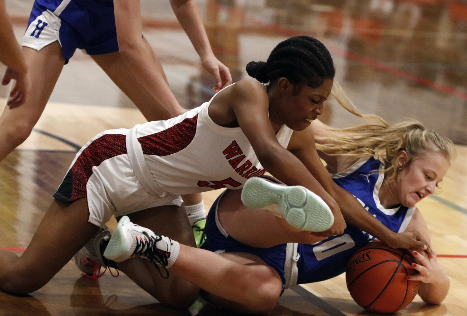 Warrenton guard Nyasia Love dives for the ball during the first half of Warrenton’s win over Hermann last week.