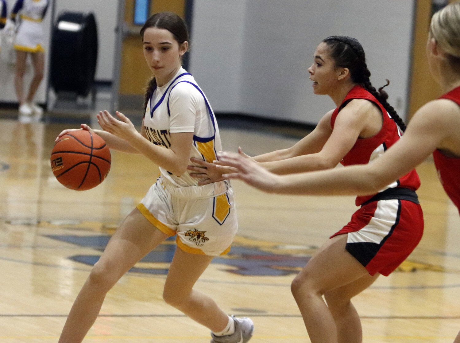 Kaitlyn Mikus (left) drives towards the basket during the second half of Tuesday night's game against Elsberry.