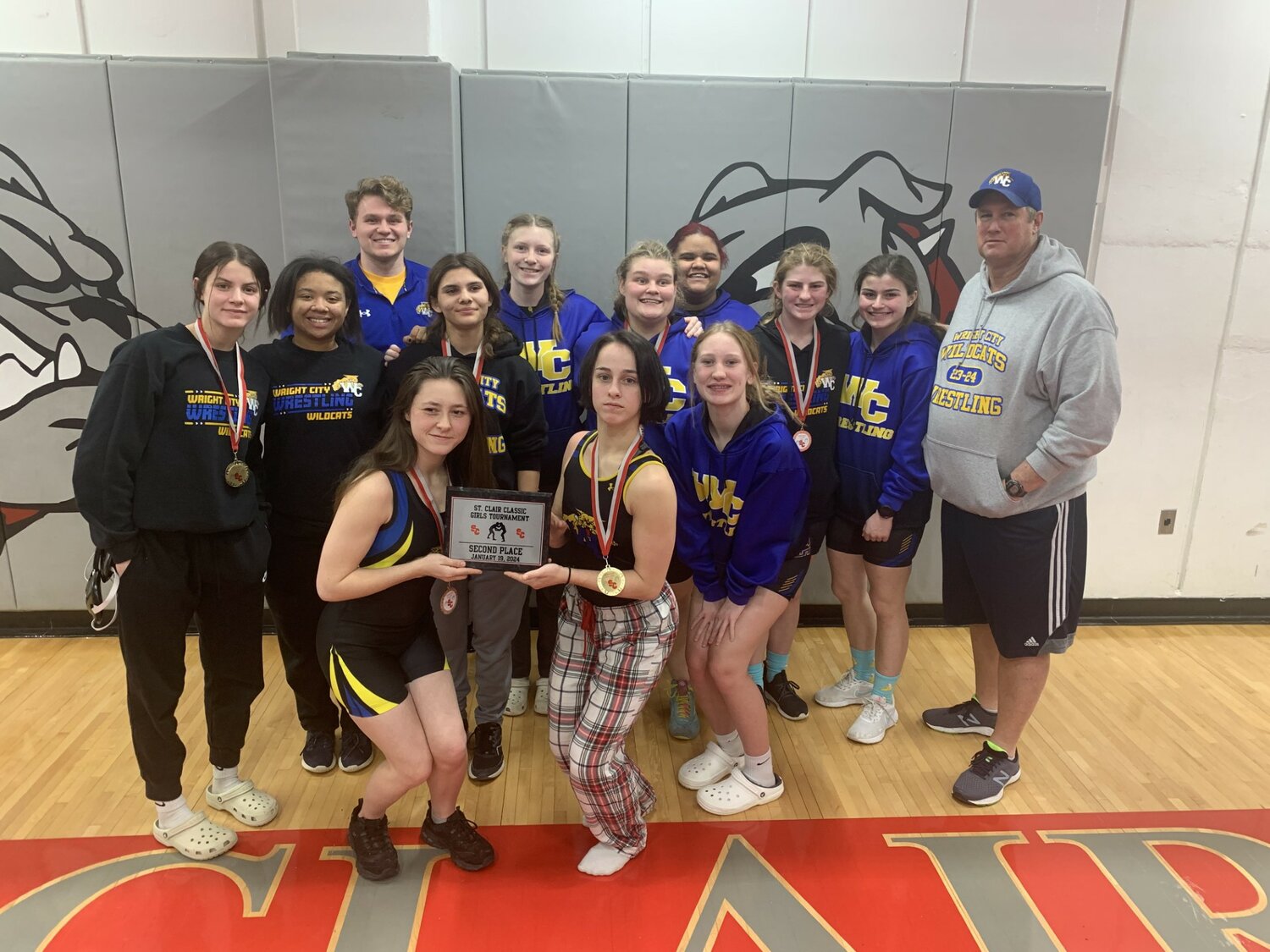 Members of the Wright City girls wrestling team are shown with the second place plaque.
