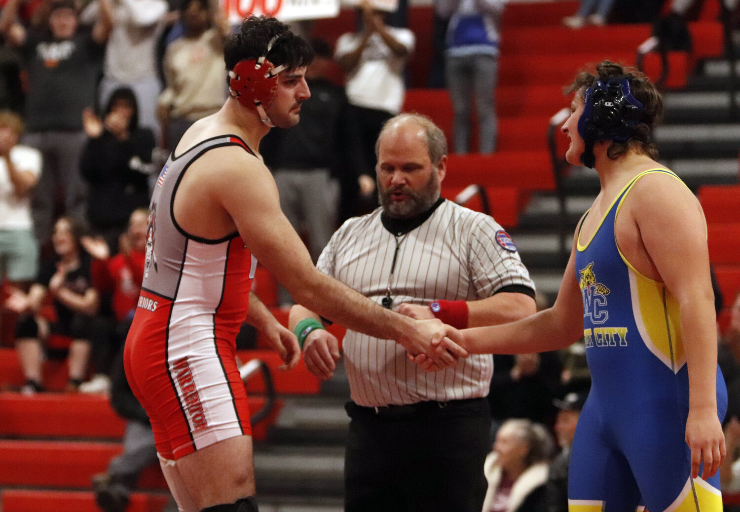 Jacob Ruff, left, shakes hands with Quincy Rice after Ruff earned his 100th win.