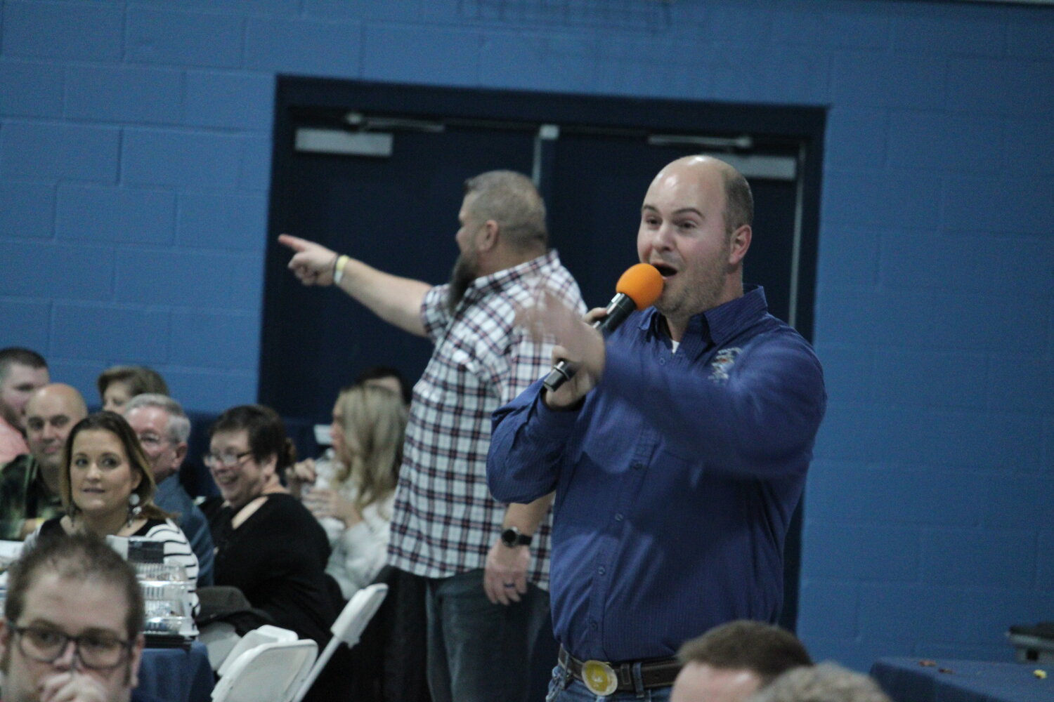 Auctioneer Dusty Thornhill recognizes a bidder while Scott Taylor watches for another during the Holy Rosary Catholic School dinner auction on Jan. 27.