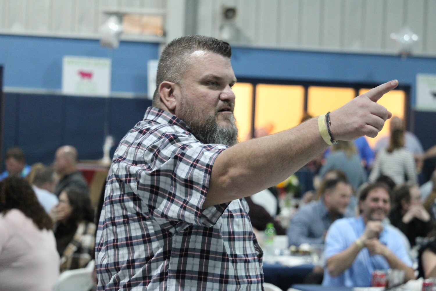 Scott Taylor points at a bidder during the auction.