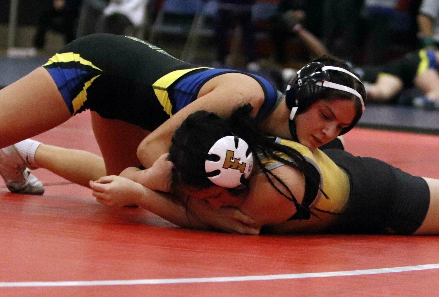 Wright City senior Elizabeth Riggs (top) prepares to pin Isabella Horn of Festus during their match earlier this season.