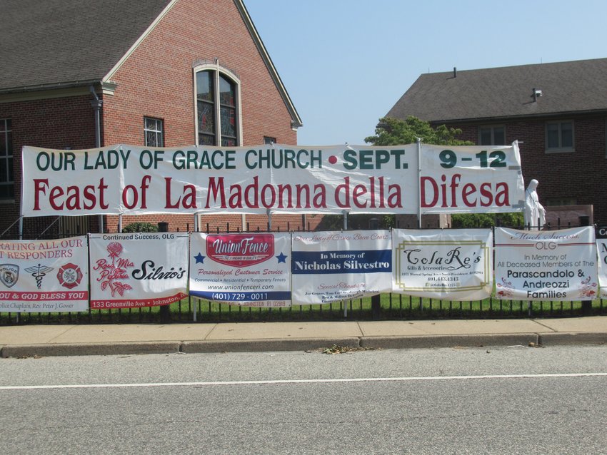 SEASONAL SIGNS: This is the large banner draped across the fence at Our lady of Grace Church  on George Waterman Road in Johnston, which also features 40 sponsorship banners for the Roman  Catholic parish’s 101st Feast and Festival.
