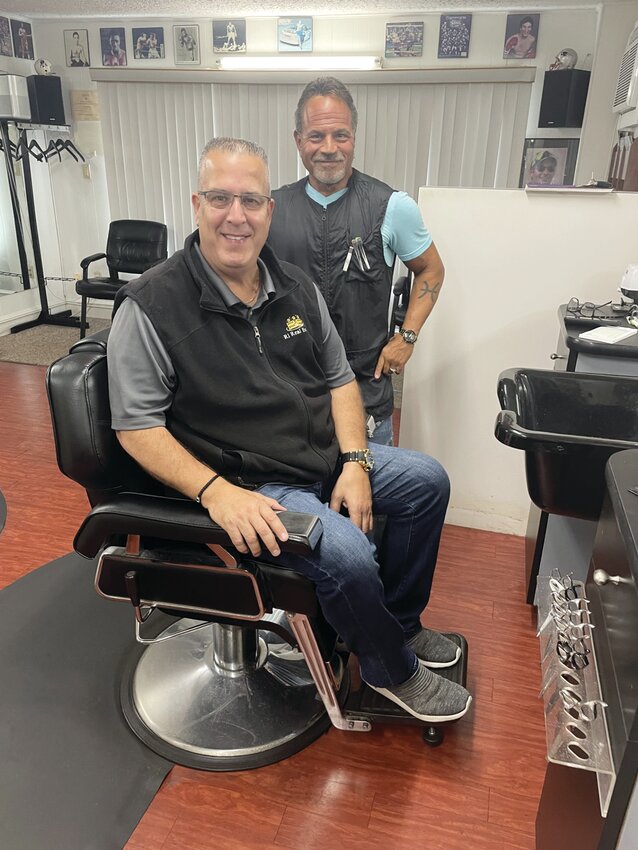 Dave takes a break from his job to greet Tim Silvia, one of his longtime customers and loyal friends. Walk-ins only for all patrons of David’s Greenwood Barber Shop.