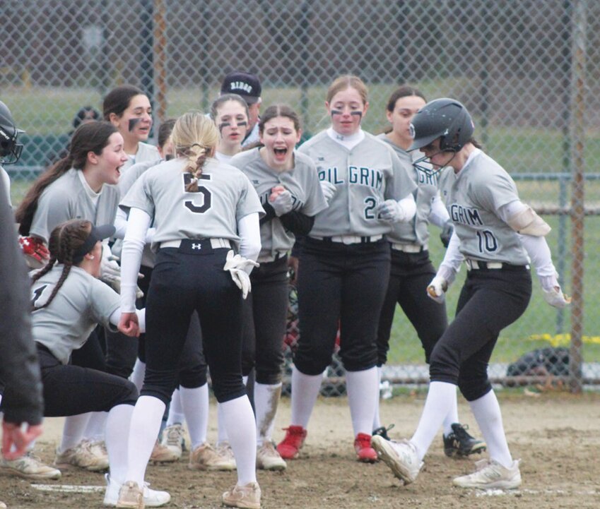 HOME RUN: The Pilgrim softball team meets Skylar Hawes at the plate after she hit a home run against Smithfield.