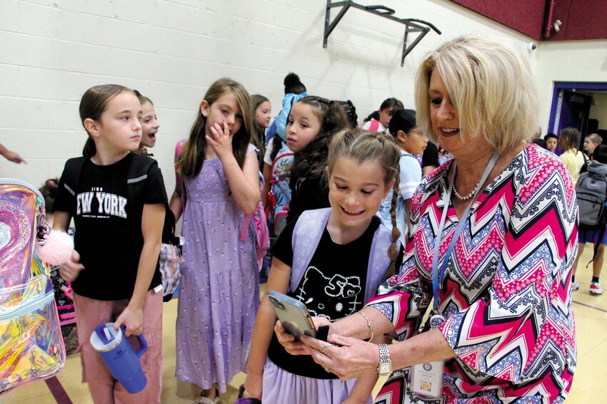 School administrators started the opening of school last Thursday with a visit to Oakland Beach Elementary that for the last academic year was relocated to Gorton during renovations. It was an occasion for taking pictures as Superintendent Lynn Dambruch demonstrated as she snapped a selfie with third grader Anna Smith. She was not alone. When we asked families to share their first day photos on Facebook, we received scores of pictures. You’ll find lots of smiling kids on page 16. (Warwick Beacon photo)