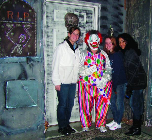 NOT FOR KIDS: &quot;The Clown&quot; gets a visit from these Spooky Walk volunteers who served as ushers for the Haunted House set up on the tennis court, created by Jimmy Rotondo.