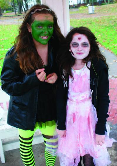 WITCHES AND ZOMBIES CAN BE FRIENDS: Leah Marsich of Cranston dressed as the witch poses with her friend Tessa Keough of Warwick.