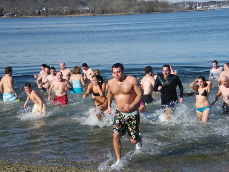 BRRRRR: Daring swimmers emerge from the water after taking a New Year's Day plunge at the Frozen Clam.