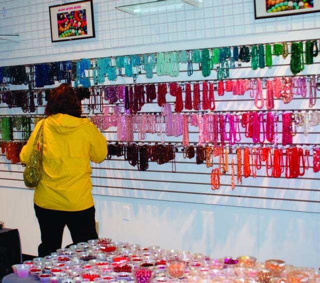 SHOPPING: A customer views the many beads and jewelry offered at The Bead Store and More. The store has relocated, offering more display area, parking and pedestrian traffic.