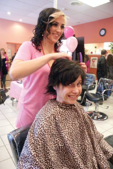 GLAM DAY: Salon Lux, located at 995 Pontiac Avenue, opened their doors and hearts to raise funds for the Gloria Gemma Breast Cancer Resource Foundation and collected donations of new socks and underwear for Project Undercover last Sunday. Between the hours of 10 a.m. and 4 p.m., the salon offered all haircuts for $10, as well as 50 percent off all other hair services including color and highlights. Also offered at the daylong event were seated chair massage by Be Healthy and Fit, Reiki treatments by First Spiritualist Church, Spirit and Physic Medium readings and tarot card readings. Refreshments and complementary make-up applications were also available. Pictured is hairstylist Kristen Blanchette and customer Heidi Morgan.