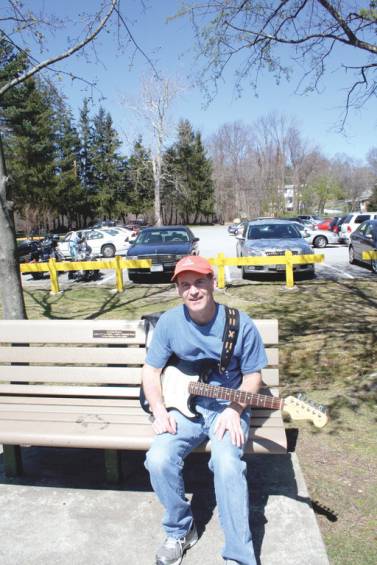 Smithfield resident Todd Stiles visited Memorial Park to soak up some sun and practice his guitar.