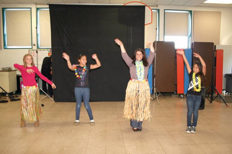 PICTURING SANDY BEACHES: Barrows Principal Roxanne Murphy, along with Evie Williams, Crystil Lima and Hailey Hollis, kick off Reading Week with some Hawaiian dance moves.
