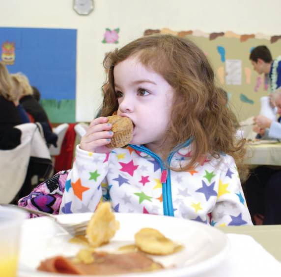CUTE AS A MUFFIN: Pictured is Lesley Cosenza, age 3, at the Almost May Breakfast held recently at the Woodridge Congregational United Church of Christ.