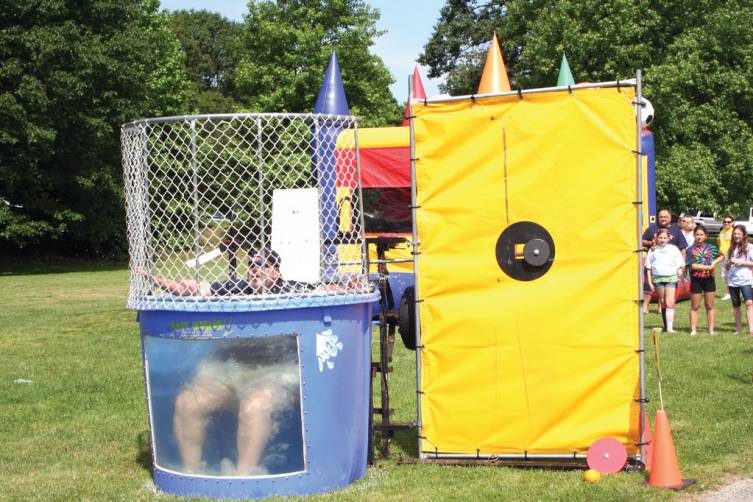 SWEET REVENGE: The Glen Hills students sought revenge for all that homework this year from Principal Jay DeCristofaro, who took more than one swim at Field Day. Several teachers, staff members and a parent volunteered to take turns in the tank.