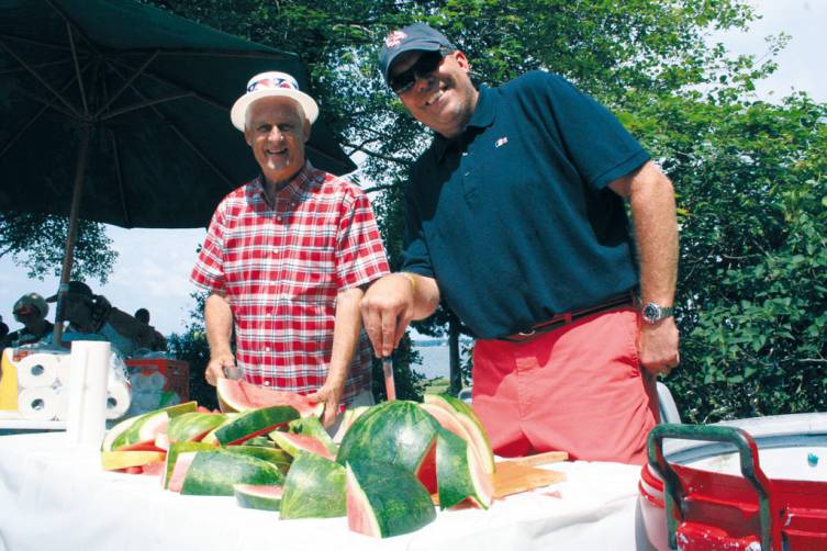CUT UPS: Jack Henriques and Brad Peterson serve fresh watermelon.