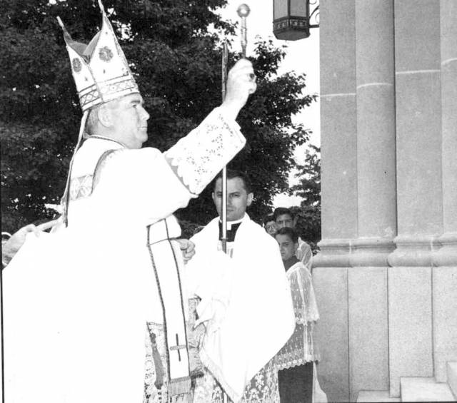 Bishop Russell McVinney blesses the doors of the new St. Rocco Church on Atwood Avenue.