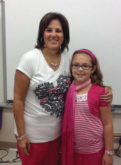 Teacher Carolyn Carnevale, a breast cancer survivor, poses with third grader Abigail Alviti, one of the many students that has helped her cause.