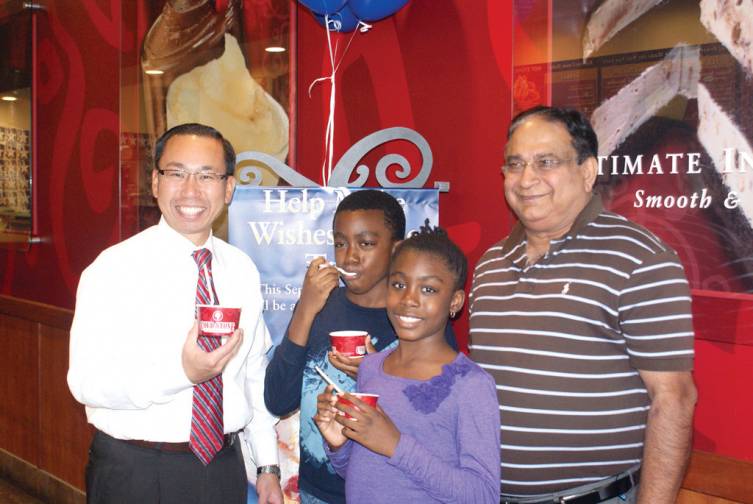 KEEPING IT COOL: Mayor Allan Fung is pictured with 9-year-old twin Wish Kids Temitope and Toluwani Olaride and Cold Stone owner Man Mehrotra. Temitope had her wish granted already, which was to travel to Disney with her family and as of now, Toluwani would like to have a pool in his bedroom. Make-A-Wish is working on something special.