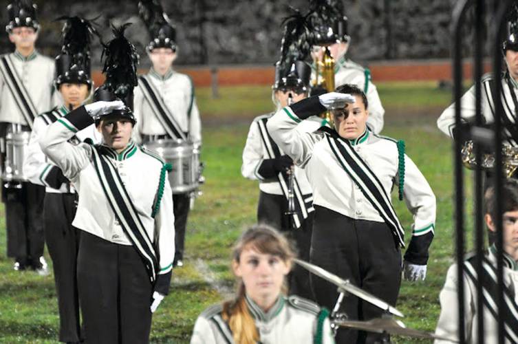 MUSIC TO THEIR EARS: Drum Majors Becky Davis and Sara Creta perform at a recent game.