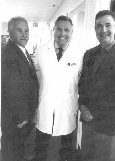 Mayor Joseph Polisena and Senator Frank Lombardo congratulate Dr. John Miele (center) for the opening of Hearing Specialists of R.I.