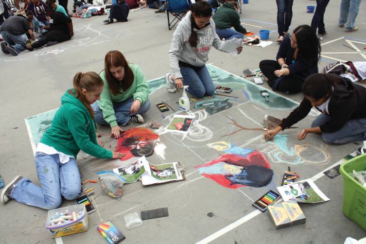 HARD AT WORK: The Cranston West art students get to work on their creation at the 13th annual Providence Street Painting Festival, where they ultimately won first place in the environmental division.