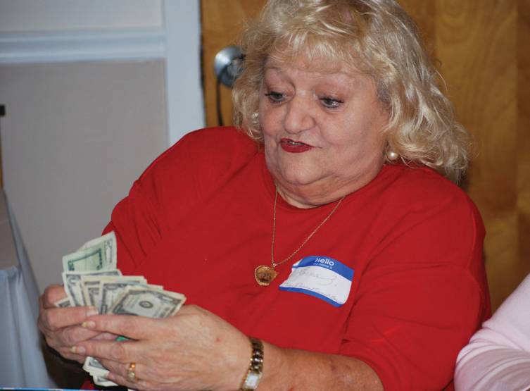 Lorna Zoglio counts the money from the raffle tickets.
