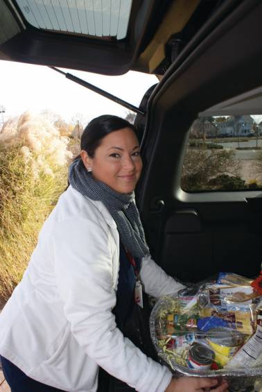 TURKEY TROT: Alicia Castore, a student and student ambassador in the Medical Billing and Coding Department at Sanford Brown, loaded her car last week for a food delivery to St. Vincent de Paul in Providence.