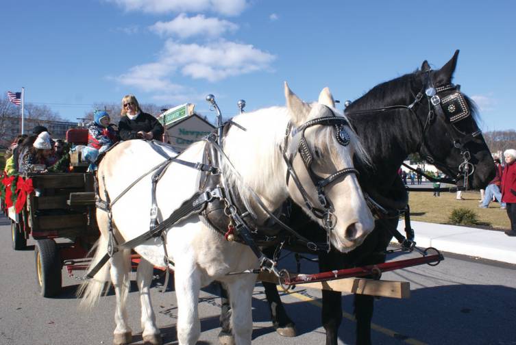 HAYRIDE: Visitors in Garden City Center not only were able to meet Mr. and Mrs. Santa Claus last Saturday, but also enjoyed horse drawn hayrides, provided by Whispering Winds Farm.