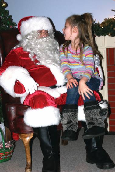 PRIVATE TIME WITH SANTA: Sitting on Santa&rsquo;s lap is 5-year-old Adrianna Pettinato during the Christmas festivities at the Oaklawn Grange.