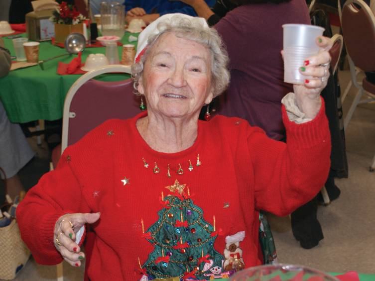 CHEERS: Known for her holiday spirit, Helen Peck of Cranston raised her cup to offer cheers for the Christmas season during the Holiday Luncheon last week.