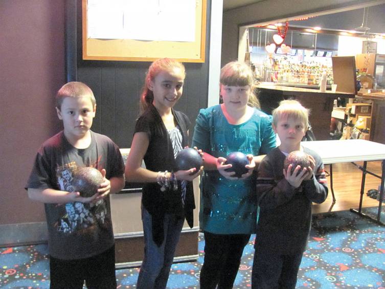 Jonathan and Felicia Guilmette and Skylar and Chase Stone were among the many children who joined adults for Cosmic bowling.