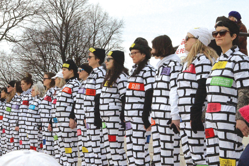 ANOTHER BRICK IN THE WALL: Demonstrators from the national organization &ldquo;BRICK X BRICK&rdquo; showed up in force, lining the stairs of the State House in white, brick-decorated outfits symbolizing that they cannot be torn down by hateful rhetoric or misogyny.