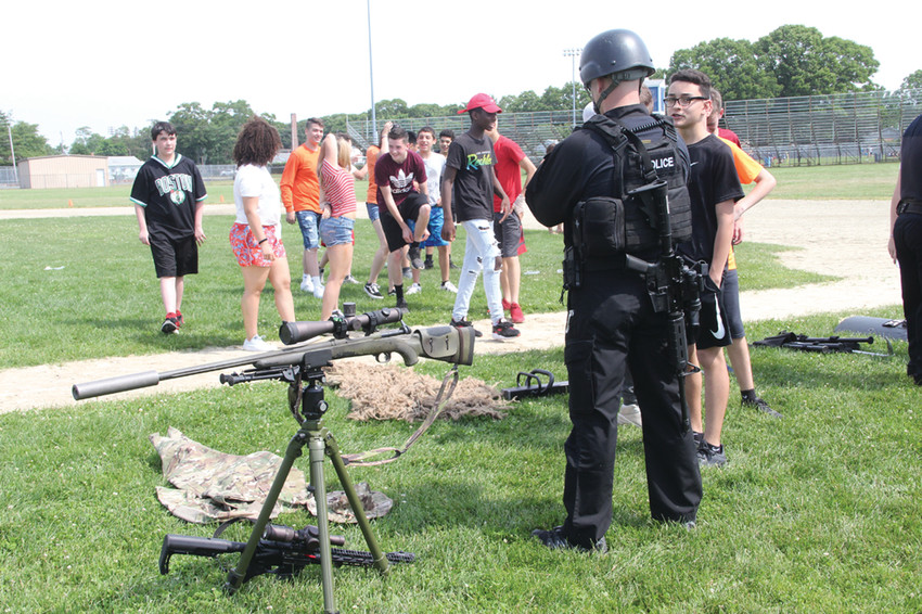 ANSWERING QUESTIONS: Police Officer Ryan Lancaster and a group from the Warwick Police Department addressed the students and answered questions as part of the field day. 