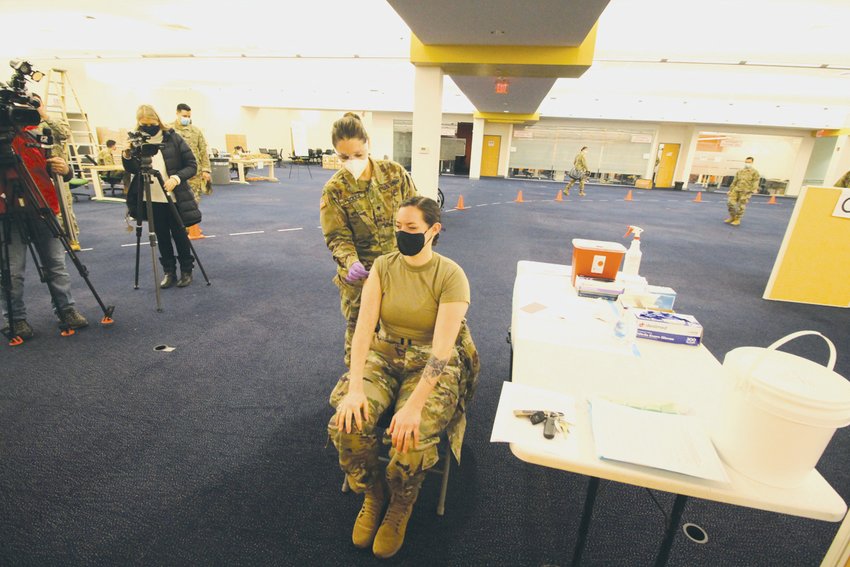 SHOWING THE WAY: The news media followed Technical Sgt. Deirdre Salvas through the process of entering the center to the point where Spc. Lindsey Proulx administered the Moderna vaccine and Salas was under observation for 15 minutes.